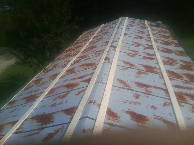 Rusted metal roof panels with new wood purlins before replacement — Storm Damage Roof Repair in Fort Branch by Roofing Brothers