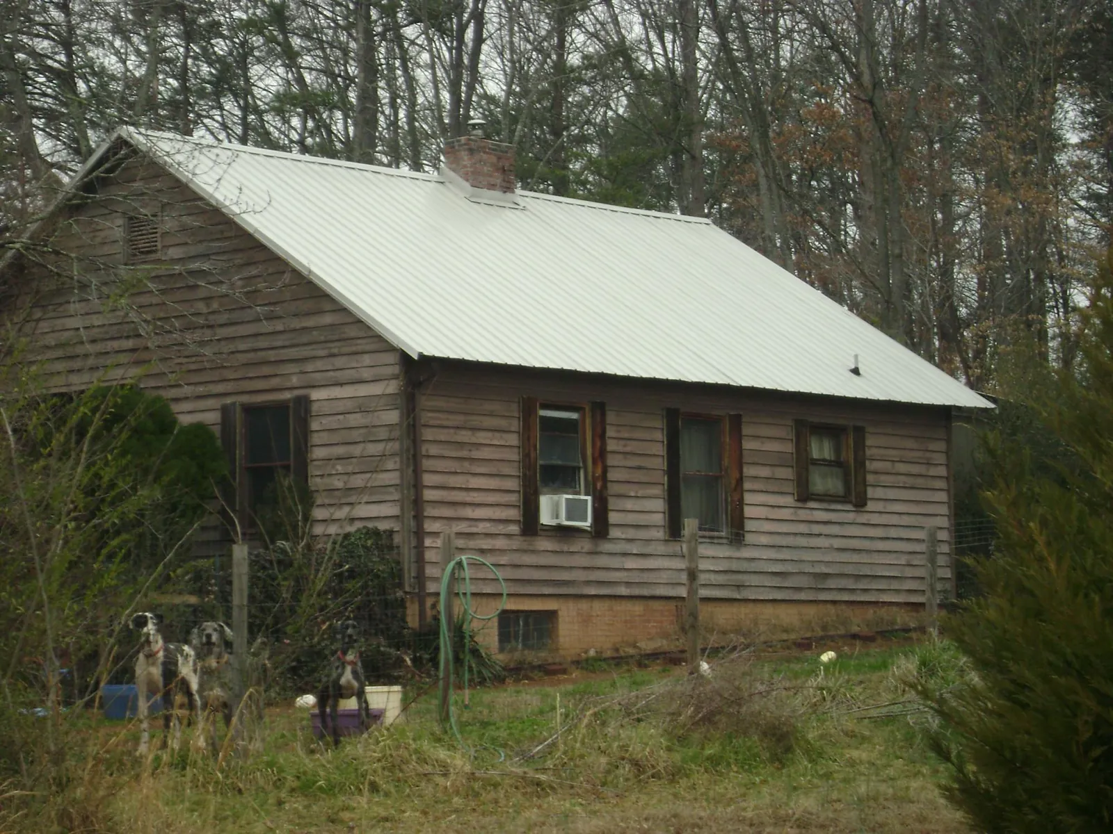 White metal roof on an old wood sided farmhouse, from a Metal Roof Installation job in Fort Branch
